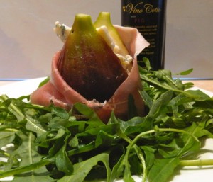 Fig wrapped in prosciutto filled with blue cheese and Vino Cotto